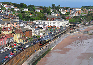 Ex-Great Western Railway 4-4-0 3440 ‘City of Truro’ passes along the sea wall through Dawlish on the Great Western mainline.